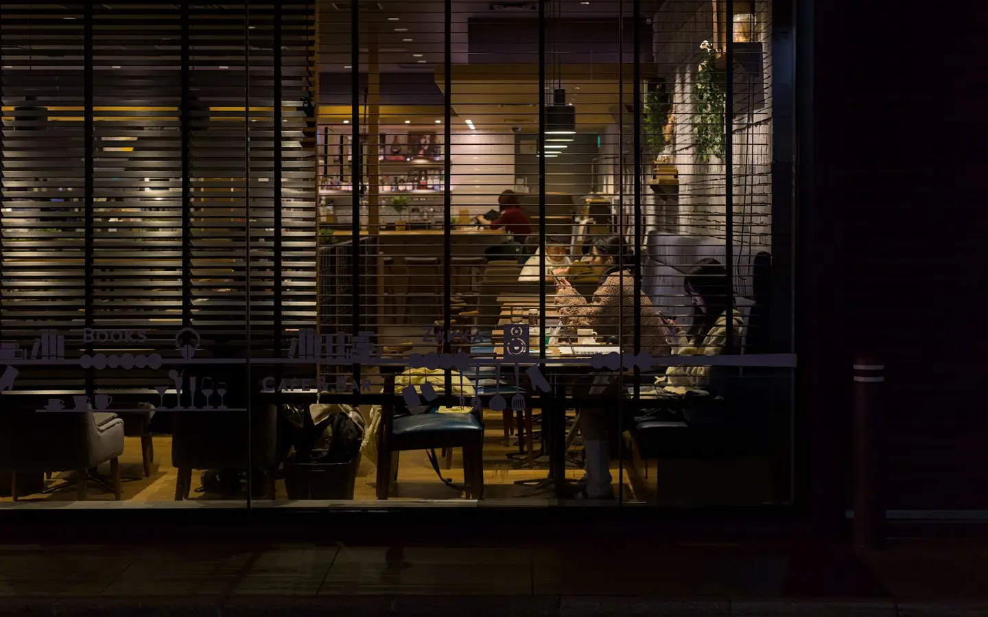 Café tables under warm lamps